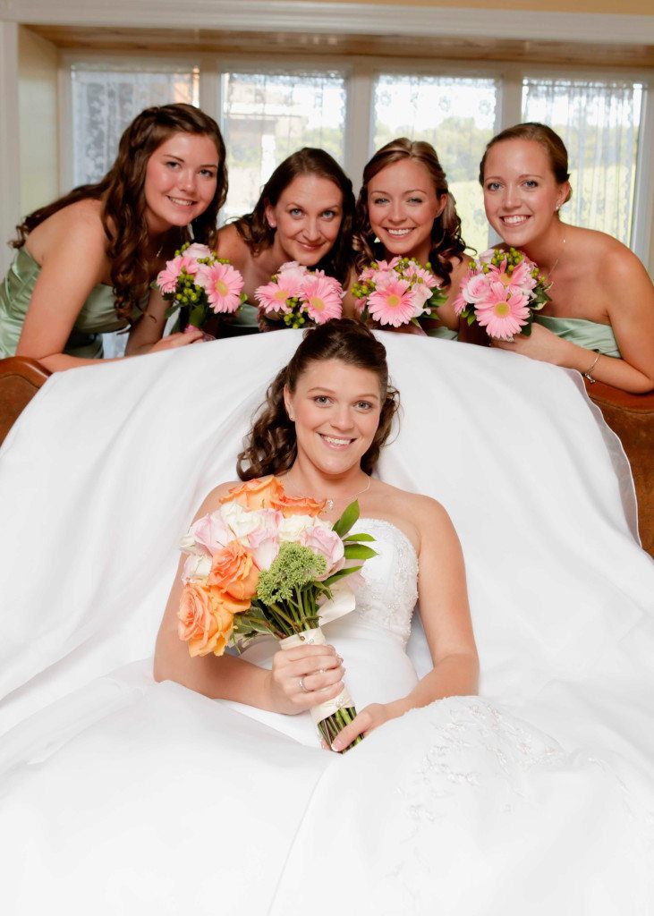 Bride and bridesmaids pose in bride's room