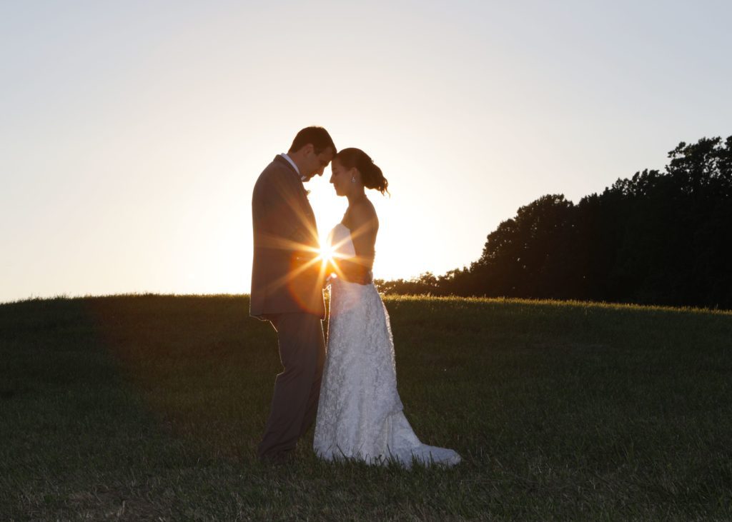 Bride and Groom kiss at sunset